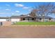 Ranch style home with solar panels, landscaped lawn, and two-car garage at 1120 E Kael Cir, Mesa, AZ 85203