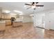 Open kitchen with island, tile floors, and stainless steel appliances at 1120 E Kael Cir, Mesa, AZ 85203