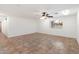 Bright living room with tile floor and ceiling fan at 1120 E Kael Cir, Mesa, AZ 85203