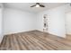 Bright bedroom with wood-look floors and an ensuite bathroom at 11225 S Tomah St, Phoenix, AZ 85044