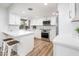 Modern white kitchen with an island and stainless steel appliances at 11225 S Tomah St, Phoenix, AZ 85044