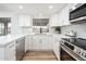 Modern white kitchen featuring stainless steel appliances at 11225 S Tomah St, Phoenix, AZ 85044