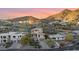 Aerial view of a modern house nestled in a hillside neighborhood with mountain views at 12 E Foothill Dr, Phoenix, AZ 85020