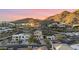 Aerial view of a modern house nestled in a hillside neighborhood with mountain views at 12 E Foothill Dr, Phoenix, AZ 85020