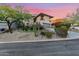 Desert landscape and two-story home with stucco exterior, attached garage, and mountain views at 12 E Foothill Dr, Phoenix, AZ 85020