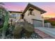 Modern house exterior with a large garage, stonework, and landscaping at 12 E Foothill Dr, Phoenix, AZ 85020