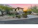 Modern house exterior with a large garage, stonework, and landscaping at 12 E Foothill Dr, Phoenix, AZ 85020