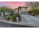 Modern house exterior with a large garage, stonework, and landscaping at 12 E Foothill Dr, Phoenix, AZ 85020