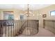 Elegant hallway with a chandelier and curved staircase at 12 E Foothill Dr, Phoenix, AZ 85020