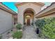 Elegant entryway with arched doorway and landscaping at 12657 N 135Th St, Scottsdale, AZ 85259