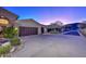 View of the home's exterior, showcasing a large driveway and desert landscaping at 12657 N 135Th St, Scottsdale, AZ 85259