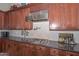 Kitchen detail, gas cooktop, granite counters, custom cabinetry at 12657 N 135Th St, Scottsdale, AZ 85259