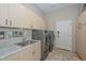 Bright laundry room with utility sink and side-by-side washer/dryer at 12657 N 135Th St, Scottsdale, AZ 85259