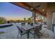 Covered patio with dining area, offering sunset views and mountain backdrop at 12657 N 135Th St, Scottsdale, AZ 85259