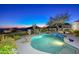 Stunning freeform pool at dusk, offering scenic sunset views at 12657 N 135Th St, Scottsdale, AZ 85259