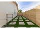 Artificial turf backyard with square stone pathways and a block wall at 13235 N 24Th Ave, Phoenix, AZ 85029