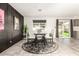 Stylish dining area with a round table and dark accent wall at 13235 N 24Th Ave, Phoenix, AZ 85029