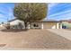 Charming ranch house featuring a white brick exterior, solar panels, and gravel driveway at 13235 N 24Th Ave, Phoenix, AZ 85029