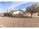 Side view of a charming white brick ranch home with landscaping at 13235 N 24Th Ave, Phoenix, AZ 85029