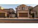 Two story home with tan exterior and two car garage at 1367 S Country Club Dr # 1024, Mesa, AZ 85210