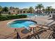 Community pool and spa with lounge chairs and palm trees at 1367 S Country Club Dr # 1024, Mesa, AZ 85210