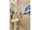 Stylish powder room with pedestal sink, mirror, and wall art at 1367 S Country Club Dr # 1024, Mesa, AZ 85210