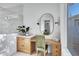 Vanity area with wood cabinets and oval mirror at 1604 E Sheena Dr, Phoenix, AZ 85022