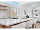 Modern kitchen island with white quartz countertops and light wood cabinets at 1604 E Sheena Dr, Phoenix, AZ 85022