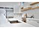 Modern kitchen sink and faucet with white quartz countertops at 1604 E Sheena Dr, Phoenix, AZ 85022