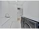 Laundry room with white cabinets and patterned tile at 1604 E Sheena Dr, Phoenix, AZ 85022