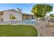 Relaxing backyard oasis with a kidney-shaped pool and artificial turf at 1604 E Sheena Dr, Phoenix, AZ 85022