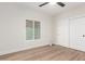 Bedroom featuring a window, closet, and wood-look floors at 16446 N 56Th Way, Scottsdale, AZ 85254