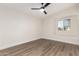 Bright bedroom with wood-look floors and ceiling fan at 16446 N 56Th Way, Scottsdale, AZ 85254