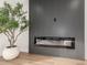 Modern linear fireplace with sleek dark gray wall at 16446 N 56Th Way, Scottsdale, AZ 85254