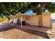 Backyard patio with covered seating area and mature trees at 1724 W 15Th Ave, Apache Junction, AZ 85120