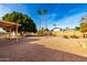 Landscaped backyard with gravel and mature trees at 1724 W 15Th Ave, Apache Junction, AZ 85120