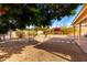 Landscaped backyard with a stone pathway and mature trees at 1724 W 15Th Ave, Apache Junction, AZ 85120