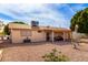 Large backyard featuring a covered patio, gravel, and mature trees at 1724 W 15Th Ave, Apache Junction, AZ 85120