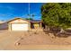 Brick ranch house with a large tree, driveway, and landscaped yard at 1724 W 15Th Ave, Apache Junction, AZ 85120