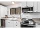 Clean kitchen features white cabinets, stainless steel appliances, and a double sink at 1724 W 15Th Ave, Apache Junction, AZ 85120