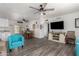 Bright living room features wood-look floors, comfy seating, and a large TV at 1724 W 15Th Ave, Apache Junction, AZ 85120