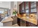 Elegant wet bar with granite countertop and wine cooler at 1805 W Parnell Dr, Phoenix, AZ 85085