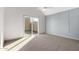 Well-lit bedroom with sliding glass door, gray accent wall, and neutral carpet at 1841 E Secretariat Dr, Tempe, AZ 85284