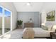 Main bedroom with sliding glass door to the backyard, and a gray accent wall at 1841 E Secretariat Dr, Tempe, AZ 85284