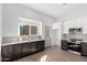 Modern kitchen with dark cabinets, white countertops, and stainless steel appliances at 1841 E Secretariat Dr, Tempe, AZ 85284