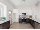 Modern kitchen featuring dark cabinetry, stainless steel appliances, and quartz countertops at 1841 E Secretariat Dr, Tempe, AZ 85284