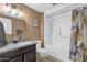 Bathroom with tub, shower, granite vanity, and updated fixtures at 18625 N 103Rd Ave, Sun City, AZ 85373