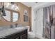 Bathroom with walk-in shower, granite vanity, and updated fixtures at 18625 N 103Rd Ave, Sun City, AZ 85373