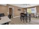 Dining area with dark wood table and chairs, and wood-look floors at 18625 N 103Rd Ave, Sun City, AZ 85373