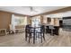 Dining area with dark wood table and chairs, and wood-look floors at 18625 N 103Rd Ave, Sun City, AZ 85373